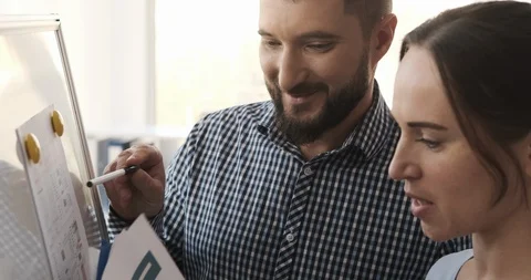 Business colleagues analyzing documents and giving high five to each other Video stock 120930829