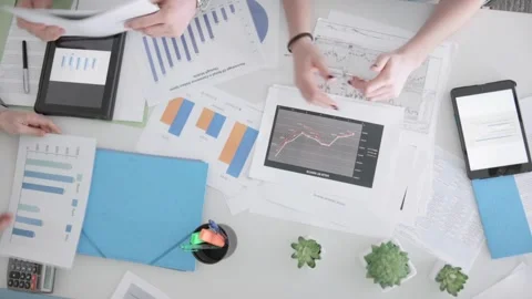 Business Colleagues Analyzing Financial Data At Their Office, Business Stock Footage 256740216