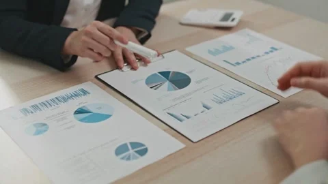 Business Colleagues Analyzing Financial Data At Their Office, Business Stock Footage 256742864