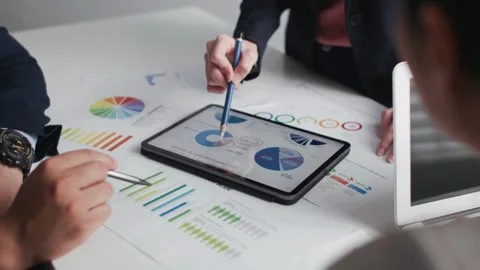Business colleagues analyzing financial data and strategies in their office Stock Footage 279933325
