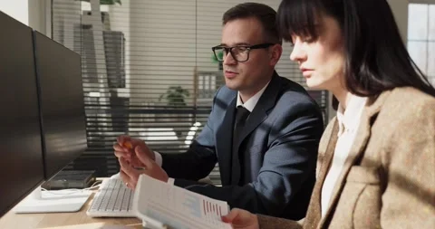 Business colleagues analyzing financial data on computer in modern office Stock Footage 340396895