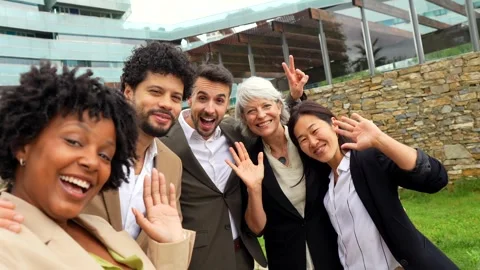 Business colleagues gesturing success while taking selfie together outdoors Stock Footage 292615908