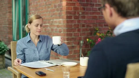 Business colleagues talking and drinking coffee in cafe HD Stock Footage