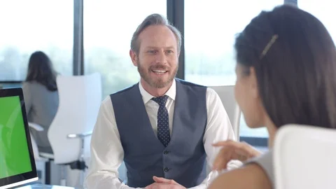 Business colleagues using a computer with green screen while having a discussion Stock Footage 108209174