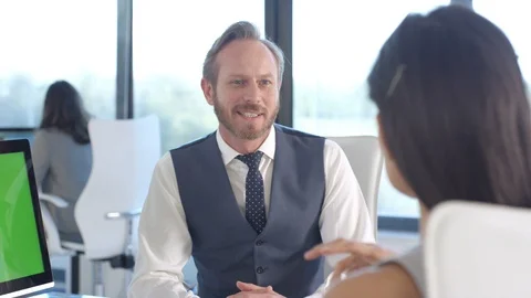 Business colleagues using a computer with green screen while having a discussion Stock Footage 108209657