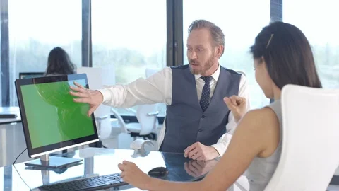 Business colleagues using a computer with green screen while having a discussion Stock Footage 108209723
