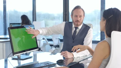Business colleagues using a computer with green screen while having a discussion Stock Footage 108210548