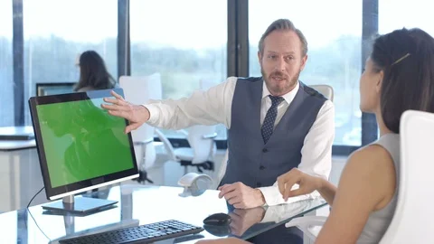 Business colleagues using a computer with green screen while having a discussion Stock Footage 108211516