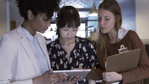 Business colleagues using digital tablet together Stock Footage 75186770