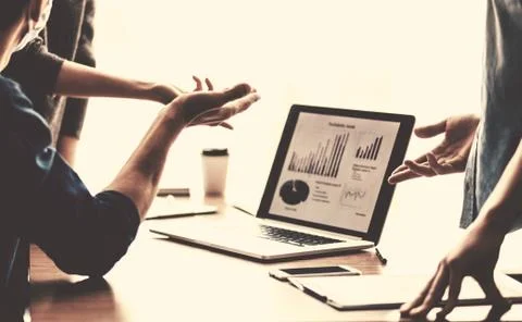 Business colleagues using a laptop to work with financial data. close up. Stock Photos