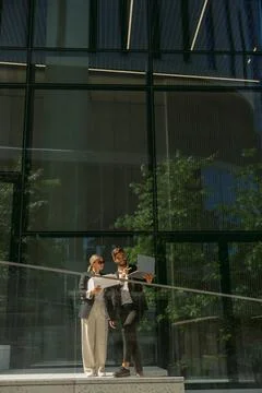 Business colleagues working with documents while standing on background of Stock Photos