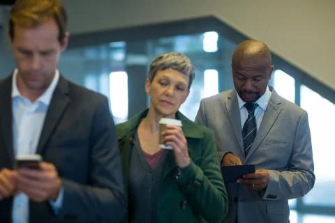 Business commuters waiting in queue Stock Photos