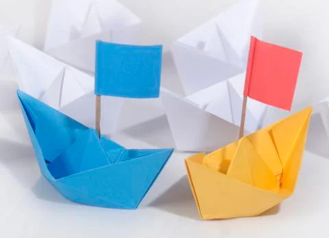 Business competition concept using two different color origami paper boats 스톡 사진