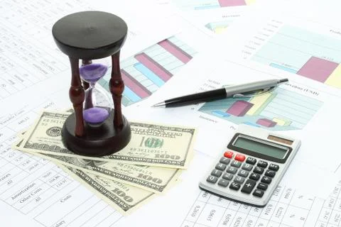 Business composition of graphs, tables, money, sand watch and pen . Stock Photos