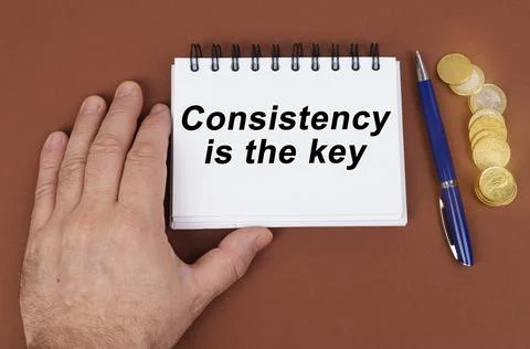 Business concept. On a brown surface are coins, a pen and a notepad with the  Foto stock