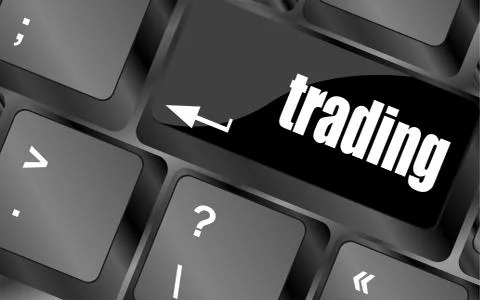 Business concept. Button on Modern Computer Keyboard with Word trading Illustrazione stock