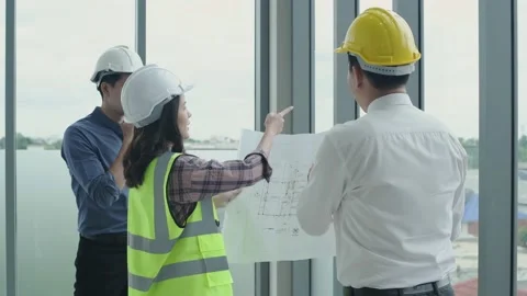 Business concept. The engineer is ordering the interior decoration workers. 4 Stock Footage 141333579