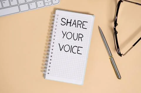Business concept. Notebook with text SHARE YOUR VOICE sheet of white paper .. Stock Photos