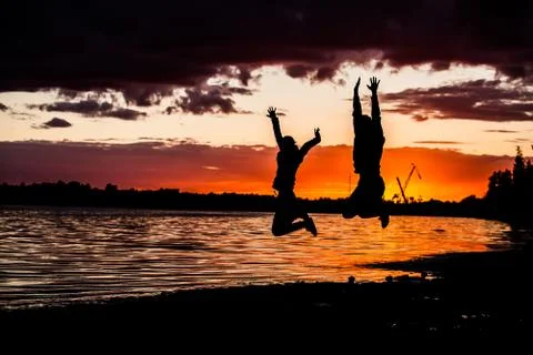 Business concept. In the rays of the sun sky silhouette  a man jumping Stock Photos