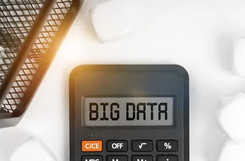 Business concept. On the table are white cubes, a black basket and a calculat Stock Photos