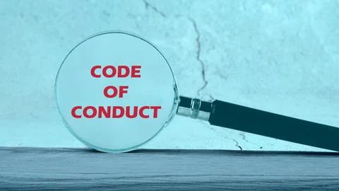 Business concept text. The words CODE OF CONDUCT through a magnifying glass o Stock Photos