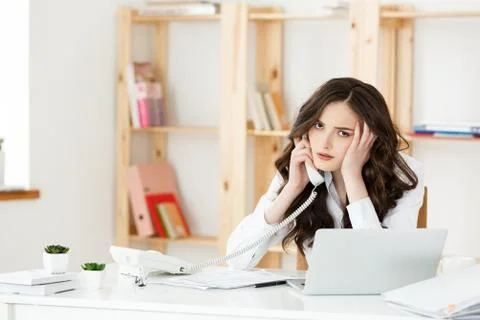 Business Concept: Unsmiling and serious cute businesswoman phoning in bright Stock Photos