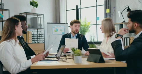 Business concept where good-looking positive confident bearded boss talking to Stock Footage 159551617