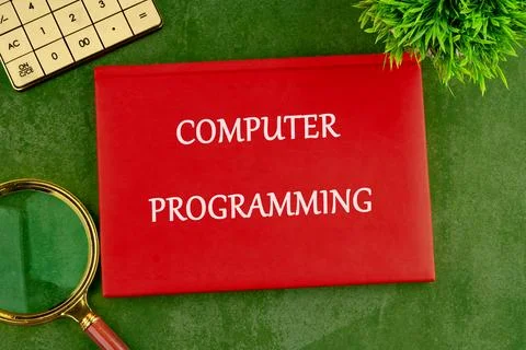 Business concept. Words COMPUTER PROGRAMMING on the cover of a red notebook o Stock-Fotos