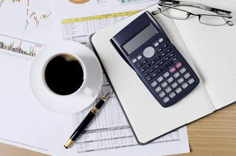 Business concept with worktable with coffee and calculator and document 스톡 사진