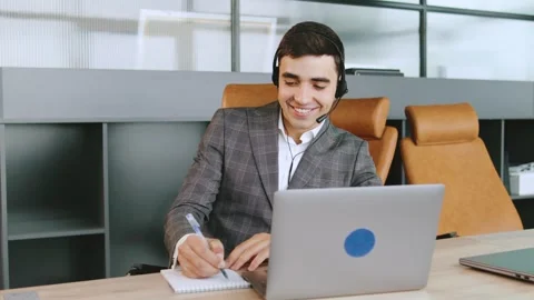 Business consultant assisting clients while working at a modern office with Stock Footage 320945496