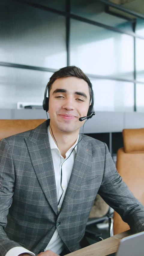 Business consultant providing technical support to clients in a modern office Stock Footage 320946412