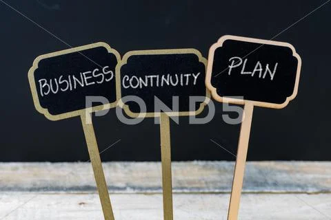 BUSINESS CONTINUITY PLAN message written with chalk on wooden mini blackboard Stock Photos
