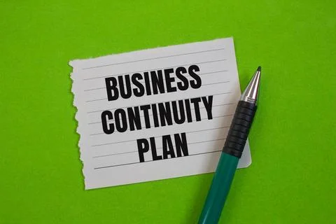 Business continuity plan message written on ripped paper piece with greenback Stock Photos