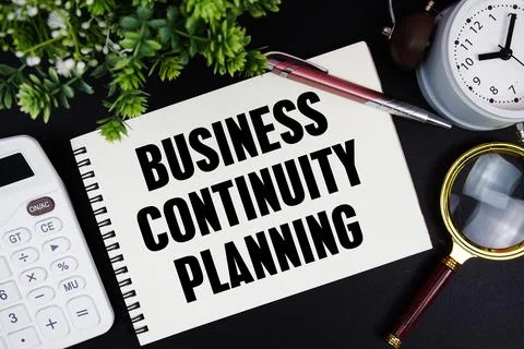 Business Continuity Planning text written on notepad with alarm clock, magn.. Stock Photos