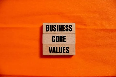 Business core values message written on wooden blocks with orange background. 写真素材