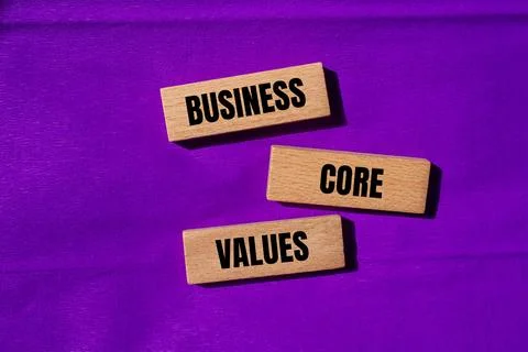 Business core values message written on wodoen blocks with purple background. 写真素材