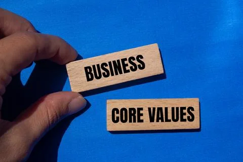 Business core values message written on wooden blocks with blue background. C 写真素材