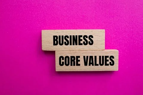 Business core values message written on wodoen blocks with pink background. C Stock-Fotos