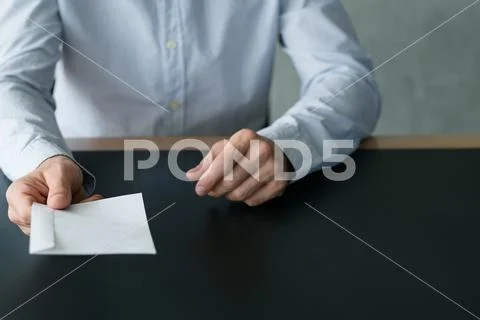 Business correspondence man passing white envelope Stock Photos