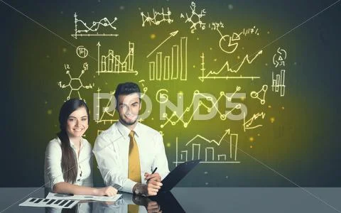 Business couple with business diagrams Stock Photos