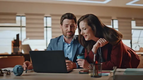 Business couple discussing computer screen at office closeup. Woman man laughing Stock Footage 255389682