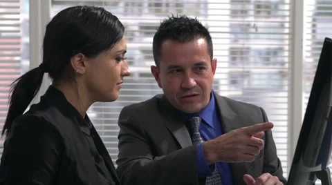 Business couple looking at computer screen Stock Footage 48025182