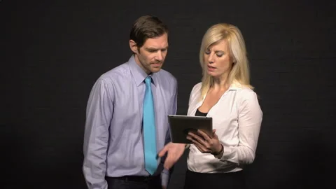 Business couple looking at tablet Stock-Footage 210598369
