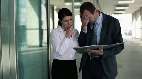 Business couple reading documents with bad news in city HD Stock-Footage 11511568