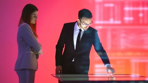 The business couple working with a virtual display Stock Footage 100680446