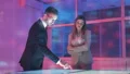 The business couple working with a virtual display on the hologram background 4k or 4k+ Resolution