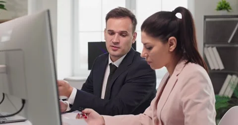 Business coworkers analyzing data at desktop computer in bright modern office Stock Footage 327097505