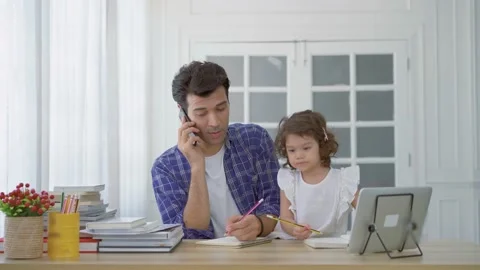 Business dad trying to work by making a phone call while take care his daughter Stock Footage 158518605