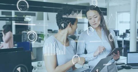 Business data analytics image over two women discussing information on tablet Stock Photos