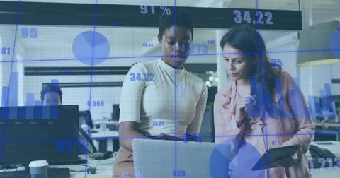 Business data charts image over two women discussing work in office 写真素材
